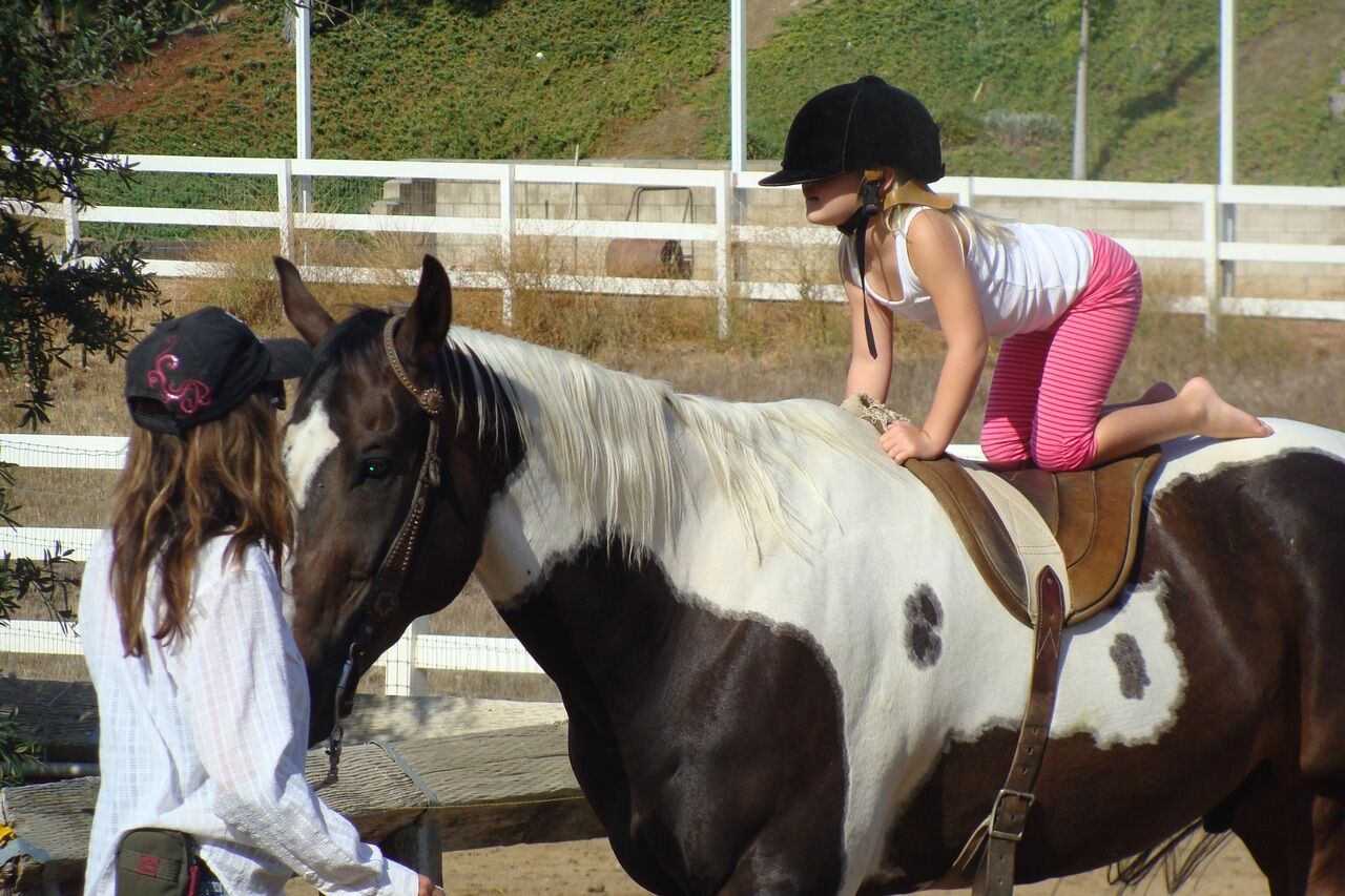 A young girl Experiencing the Thrill of Horseback Riding at Camps in San Diego